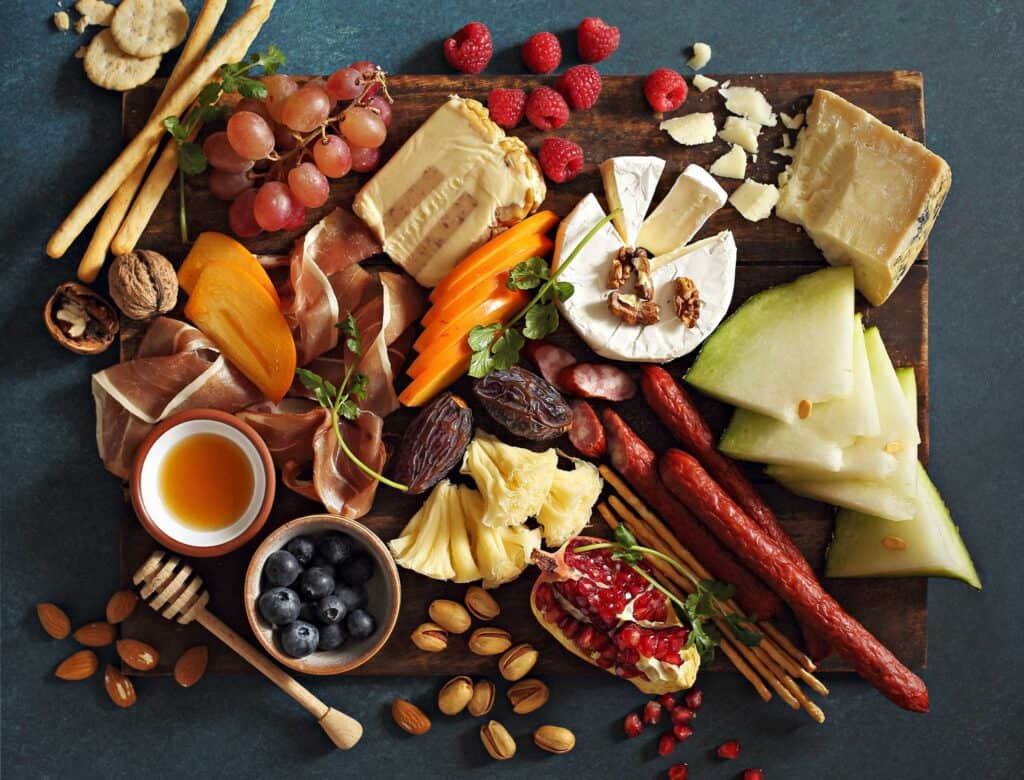 family snack platter with fresh meats, cheeses, spreads, dips, and fruits