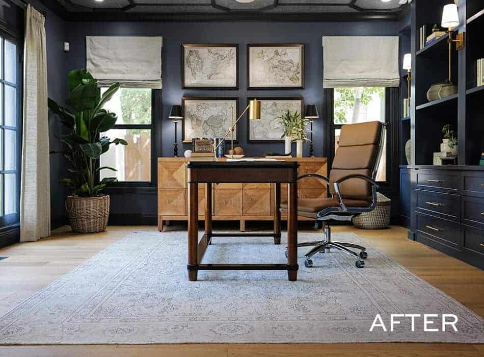 Sophisticated home office with dark walls, framed artwork, wooden desk, and leather chair