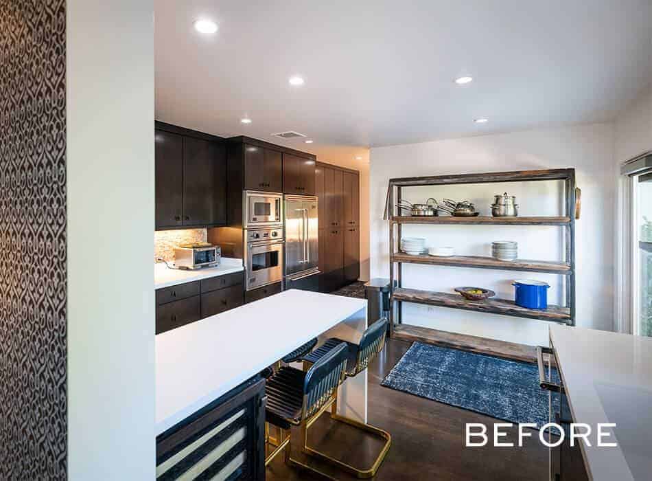 Kitchen with dark cabinets, stainless steel appliances, open wooden shelves, and a white countertop dining area