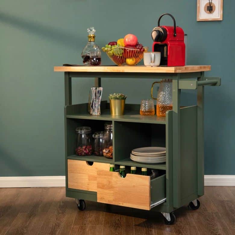 green kitchen island with wooden top and open shelving