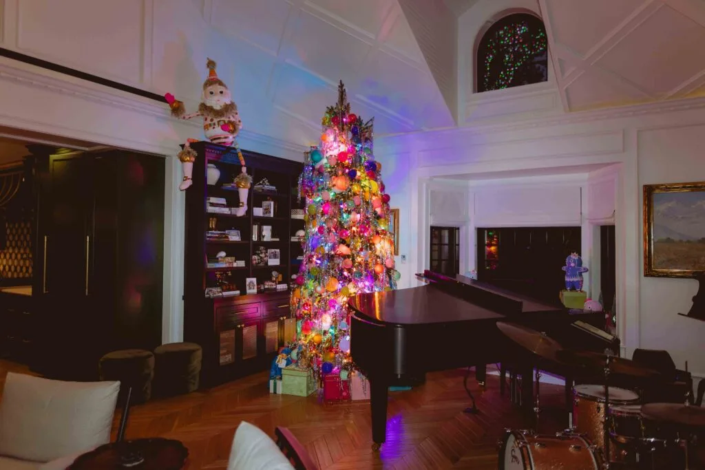 jonathan scott and zooey deschanel's living space with piano and christmas tree