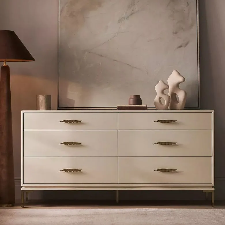 white dresser with leaf drawer pulls