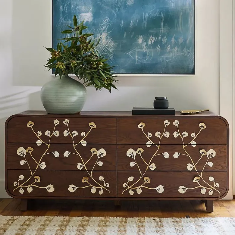 dark wooden dresser with floral inlay design