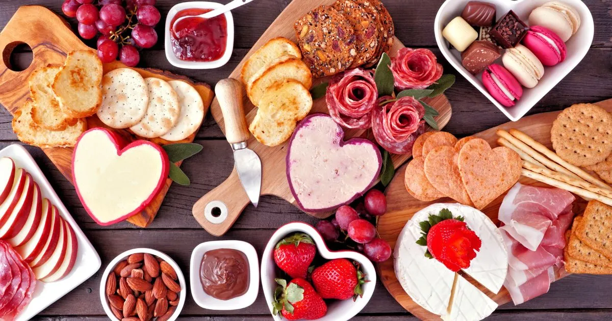 best valentine's day gift baskets, cheeses and sweet treats spread on a table in shapes of hearts