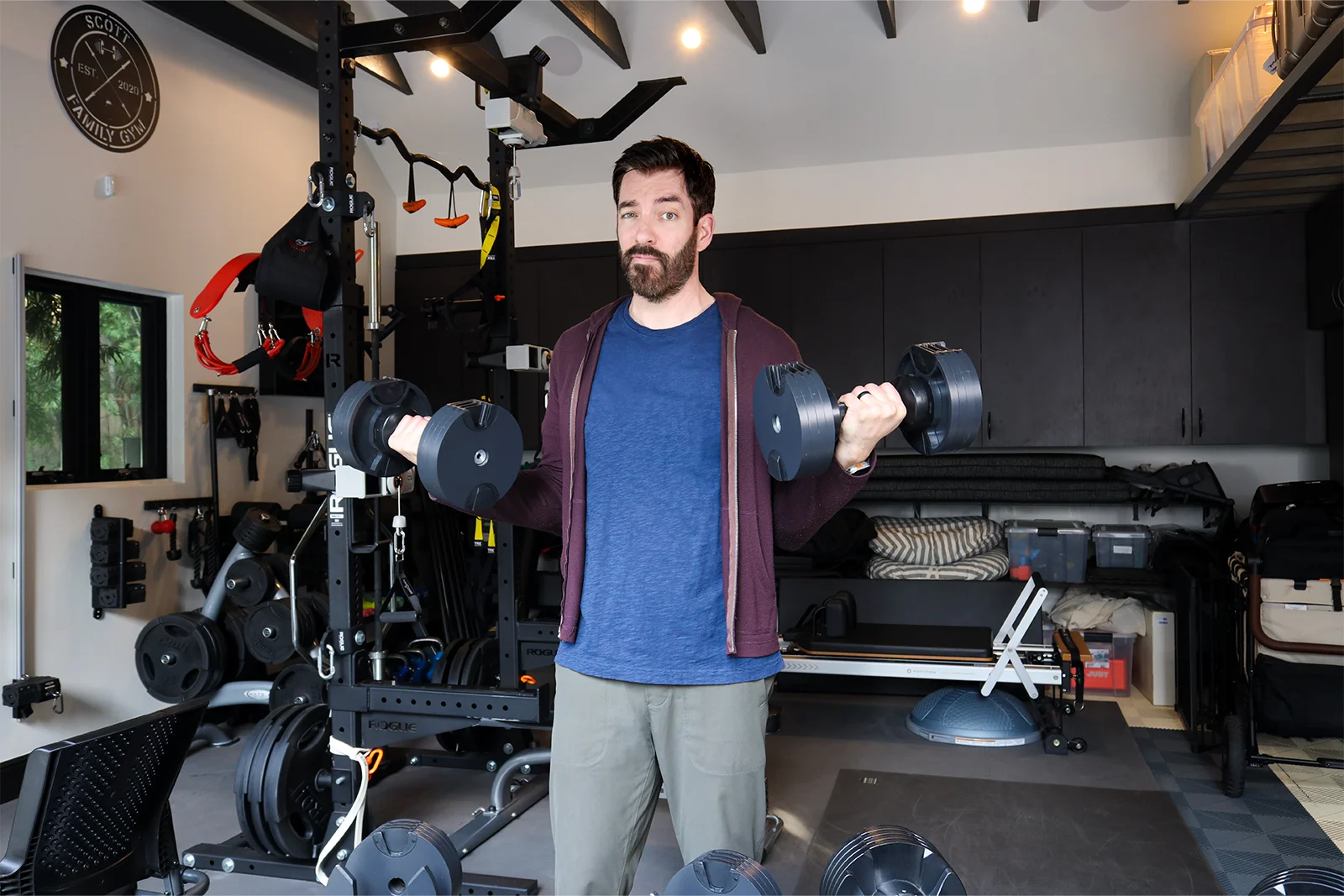 drew scott home gym tour, lifting weights in his california garage